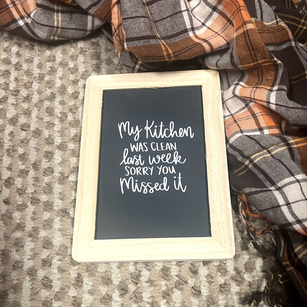 Chalkboard wall piece that says “My Kitchen was clean, sorry you missed it.”